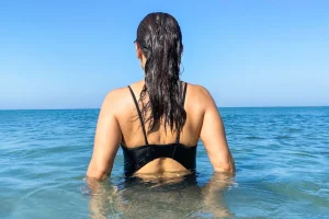 woman wading in ocean